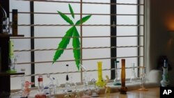 FILE - Marijuana equipment lines a window at the Minerva medical cannabis dispensary in Santa Fe, New Mexico, June 11, 2019.