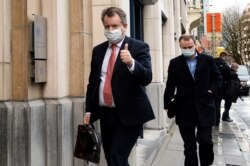 Britain's chief Brexit negotiator David Frost gives a thumb up as he arrives at the British Embassy during negotiations, in Brussels, Dec. 24, 2020.