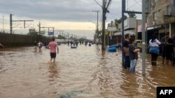 This handout picture released by the Canoas City Hall shows people helping to rescue flood victims in Canoas, Rio Grande do Sul state, Brazil on May 4, 2024.