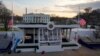 Workers continue with the finishing touches on the presidential reviewing stand on Pennsylvania Avenue outside the White House, Jan. 16, 2025, in Washington, ahead of President-elect Donald Trump's inauguration.