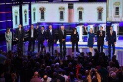 Democratic presidential hopefuls, from left, Marianne Williamson, John Hickenlooper, Andrew Yang, Pete Buttigieg, Joseph R. Biden, Bernie Sanders, Kamala Harris, Kirsten Gillibrand, Michael Bennet, and Eric Swalwell in Miami, June 27, 2019.