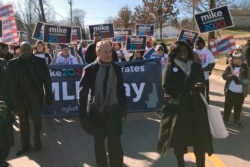 FILE - Democratic presidential candidate Michael Bloomberg walks with supporters along the route of the Little Rock "marade," marking the Martin Luther King Jr. holiday in Little Rock, Arkansas, Jan. 20, 2020.