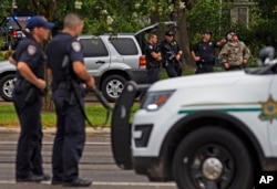Law enforcement officers man a road block after police officers were shot in Baton Rouge, Louisiana, July 17, 2016.