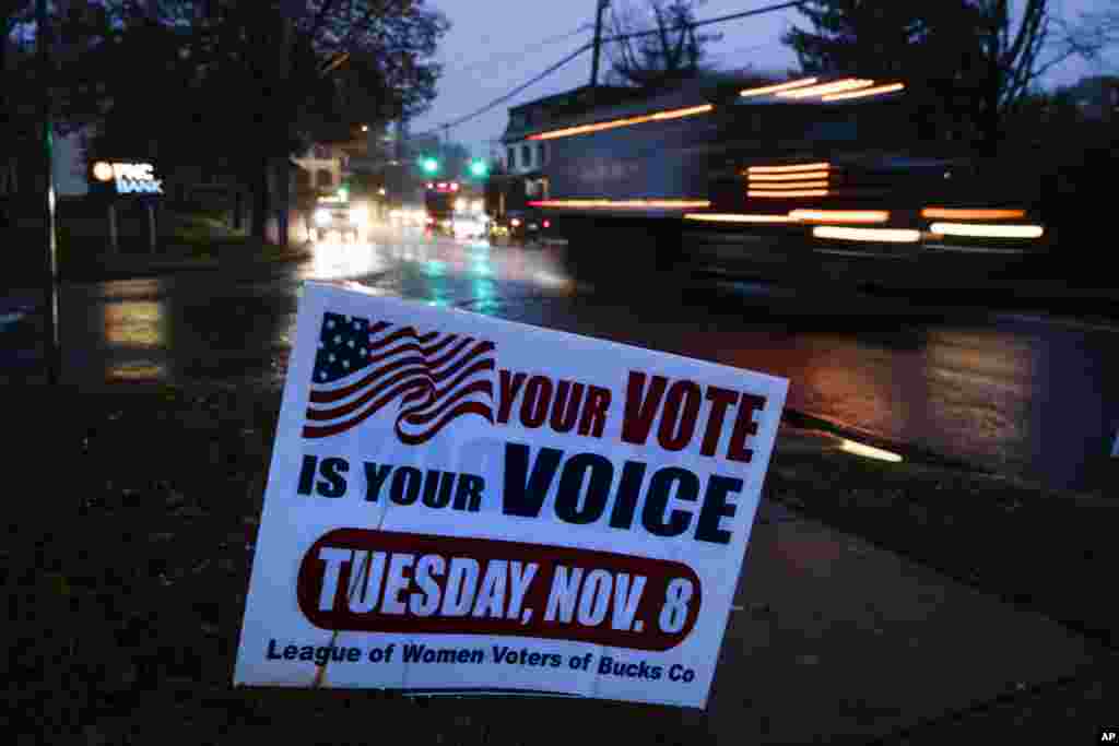 A truck passes a sign posted at a polling place in Buckingham, Pennsylvania, Nov. 6, 2018. 
