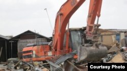 A bulldozer demolishes homes in Badia East, Lagos, Nigeria, February 23, 2013. (Social and Economic Rights Action Center (SERAC))