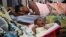 In this Sept. 10, 2010 photo, Yaumu Sesay, 40, looks on as her two-day old baby boy, Allasane, is held by his grandmother at Princess Christian Maternity Hospital in Freetown, Sierra Leone. In Sierra Leone and across the world are success stories in the b