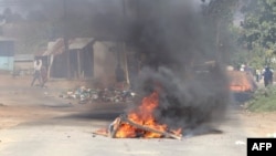 FILE - A barricade is set ablaze in the road during a protest in Mbabane, Eswatini, June 29, 2021. Residents have for months been holding rallies against Africa's last absolute monarchy