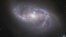 FILE - Looking deep into the Universe, the NASA/ESA Hubble Space Telescope catches a passing glimpse of the numerous arm-like structures that sweep around this barred spiral galaxy, known as NGC 2608. 