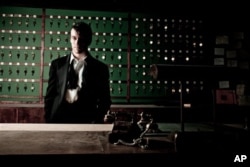 In this theater publicity image released by the O+M Co., Luke Murphy is shown in a scene from "Sleep No More," performing at The McKittrick Hotel in New York.