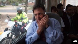 FILE - Brazilian Senator Aecio Neves rides in a van with other Brazilian senators, escorted by Bolivarian Police on motorcycles, after departing the airport in La Guaira, Venezuela, June 18, 2015.
