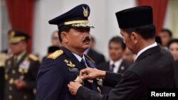 Indonesian President Joko Widodo attaches the rank to the new Armed Forces Chief Marshall Hadi Tjahjanto during an inauguration ceremony at the Presidential Palace in Jakarta, Indonesia, Dec. 8, 2017, in this photo taken by Antara Foto. 