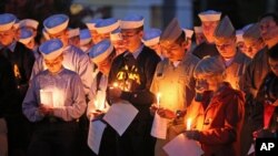 FILE - Maine Maritime Academy students in Castine, Maine, bow their heads Oct. 6, 2015, during a vigil of hope for the missing crew members of El Faro. All 33 members of the crew were killed.