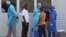 In this photo taken on March 29, 2014, medical personnel at the emergency entrance of a hospital receive suspected Ebola virus patients in Conakry, Guinea.