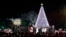 FILE - President Barack Obama, with Michelle Obama, and daughter Sasha, sing with Santa Claus and others during the lighting ceremony for the 2016 National Christmas Tree on the Ellipse near the White House, Dec. 1, 2016.