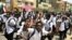 Sudanese students protest in the capital Khartoum, July 30, 2019, a day after teenagers were shot at a rally against shortages of bread and fuel in the town of al-Obeid, about 420 kilometers southwest of the capital.
