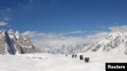 People hike down the Baltoro glacier in the Karakoram mountain range in Pakistan September 7, 2014. REUTERS/Wolfgang Rattay/File Photo
