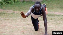 FILE - Paulo Amotun Lokoro, a refugee from South Sudan, part of the refugee athletes who qualified for the 2016 Rio Olympics, stretches during a training session in Ngong township near Kenya's capital Nairobi, June 9, 2016.