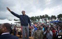 FILE - In this Saturday, Sept. 5, 2015 file photo, Rwanda's President Paul Kagame waves to the crowd before speaking at a baby gorilla naming ceremony in Kinigi, northern Rwanda.