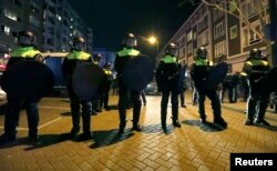 Police block off the street outside the Turkish consulate in Rotterdam where a crowd gathered to await the arrival of the Turkish Family Minister Fatma Betul Sayan Kaya, who decided to travel to Rotterdam by land after Turkish Foreign Minister Mevlut Cavusoglu's flight was barred from landing by the Dutch government, in Rotterdam, Netherlands, March 11, 2017.