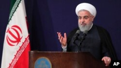 In this photo released by the official website of the office of the Iranian Presidency, President Hassan Rouhani addresses the nation in a televised speech in Tehran, Aug. 6, 2018.