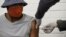 FILE - A volunteer receives an injection from a medical worker during the country's first human clinical trial for a potential vaccine against the novel coronavirus, at Baragwanath Hospital in Soweto, South Africa, June 24, 2020.