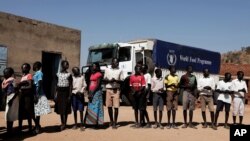 Children wait in line to receive aid during a visit organized by The World Food Program (WFP) at Koge School, in the conflict-affected remote town of Kauda, Nuba Mountains, Sudan, Jan. 9, 2020.