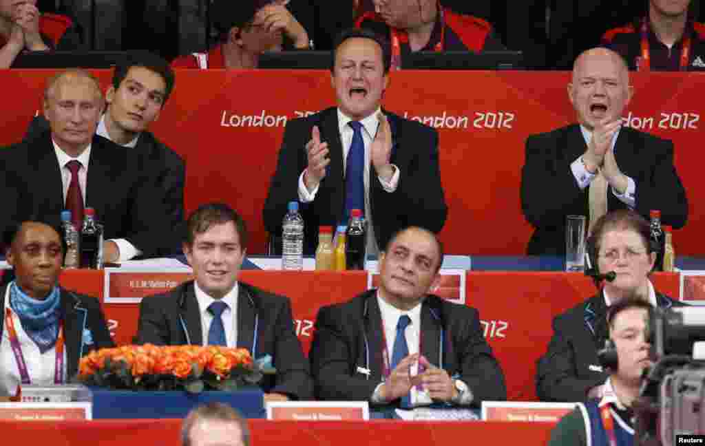 Russian President Vladimir Putin, Britain's Prime Minister David Cameron and Foreign Secretary William Hague watch the women's -78kg final judo match between Kayla Harrison of the U.S. and Britain's Gemma Gibbons.