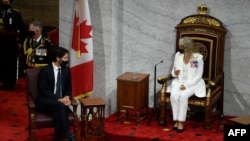 Canadian Prime Minister Justin Trudeau speaks with Governor General Julie Payette before she reads the speech from the throne in the Senate chamber in Ottawa, Sept. 23, 2020, in Ottawa, Ontario. 