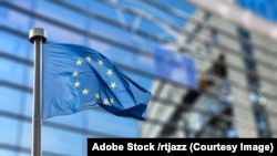 飘扬在欧盟议会大楼前的欧盟旗帜。