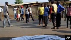 FILE - The body of a man killed is laid on a street in Bujumbura, Burundi after polls opened for the presidential elections, July 21, 2015. 