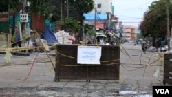 បារ៉ាស និងខ្សែរចងបិទផ្លូវចូលតំបន់ក្រហម ក្នុងសង្កាត់បឹងសាឡាង ខណ្ឌទួលគោក ក្នុងអំឡុងពេលបិទខ្ទប់ នៅរាជធានីភ្នំពេញ នៅថ្ងៃទី២៣ ខែមេសា ឆ្នាំ២០២១។ (កាន់ វិច្ឆិកា/វីអូអេ)