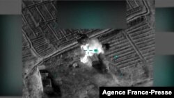 This image grab from a handout video made available by the US-led coalition on Jan. 5, 2022, shows the coalition targeting with artillery outside the eastern town of Al-Mayadeen in Deir Ezzor province, what they reported as being the source of an earlier 