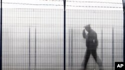 A Romanian border police officer patrols a railway border crossing point between Romania and Moldova in Ungheni, Romania, 18 Jan 2011