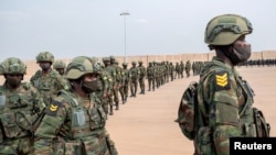 FILE - Rwandan military troops depart for Mozambique to help the country combat an escalating Islamic State-linked insurgency that threatens its stability, at the Kigali International Airport in Kigali, Rwanda July 10, 2021.