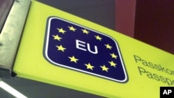 FILE - An EU sign greets travelers at Tegel Airport, in Berlin, Germany, Feb. 28, 2001.