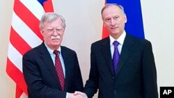 U.S. National Security Adviser John Bolton, left, and Russian Security Council chairman Nikolai Patrushev pose for a photo prior their official talks in Moscow, Russia, Oct. 22, 2018. 