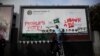 Members of Britain's Labor Party write on a billboard why they want party leader Jeremy Corbyn to back a second referendum on Britain's European Union membership, during a publicity stunt in Islington North, Corbyn's north London constituency, Feb. 12, 2019.