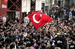 FILE - People try to march after security members closed the city's landmark Taksim Square and Gezi Park, on the first anniversary of the Gezi protests in Istanbul, Turkey, May 31, 2014. A government backed redevelopment plan for Gezi Park in Istanbul sparked anger and morphed into nationwide anti-government protests in June, leaving eight people dead and thousands other injured.
