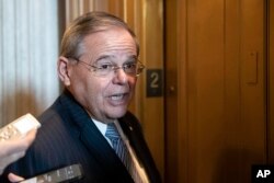 FILE - Sen. Bob Menendez, D-N.J., talks with reporters on Capitol Hill, Oct. 11, 2018.