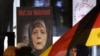FILE -A poster with the writing "Courage to speak the truth" depicts German Chancellor Angela Merkel wearing a veil during a demonstration of the Legida anti-Islamization movement, an offshoot of Pegida, in Leipzig, Jan. 30, 2015. 