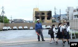 A Kyoto City firefighter stands near the scene