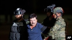 FILE - Joaquin "El Chapo" Guzman is escorted to a helicopter by Mexican soldiers and marines in Mexico City, Jan. 8, 2016
