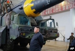 FILE - This image made from video of an undated still image broadcast in a news bulletin by North Korea's KRT on Monday, May 15, 2017, shows leader Kim Jong Un at what was said to be a missile test site at an undisclosed location in North Korea.