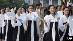 FILE - In this 2005 photo, North Korea's female cheerleaders, including a woman (right) believed to be North Korean leader Kim Jong-Un's current wife Ri Sol-Ju, attend the 2005 Asian Athletics Championships in Incheon. ( AFP PHOTO / Dong-A Ilbo)