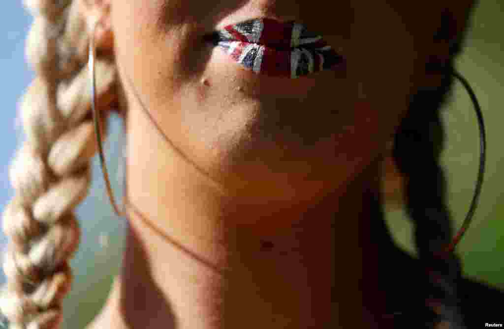 A woman poses for a picture ahead of the wedding of Britain’s Prince Harry to Meghan Markle in Windsor, Britain, May 19, 2018.