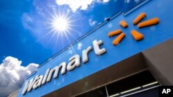 This June 25, 2019, file photo shows the entrance to a Walmart in Pittsburgh. Walmart launched a pilot program Wednesday, Sept. 9, 2020, using drones to deliver groceries and household essentials in a North Carolina city. (AP Photo/Gene J. Puskar, File)