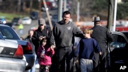 In the U.S., parents reunite with their children following a shooting at Sandy Hook Elementary School in Newtown, Connecticut. A gunman killed 27 people dead, including 20 children, on Dec. 14, 2012.