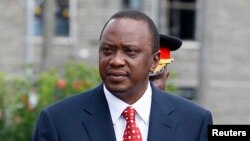 FILE - Kenya's President Uhuru Kenyatta prepares to inspect a guard of honor before the opening of the 11th Parliament at the National Assembly Chamber in Nairobi, April 16, 2013.