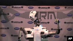 Some day, a robot might find a hidden bomb or help a disabled person select a shirt and button it.