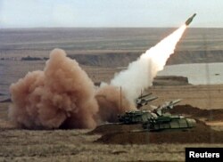 FILE - A Buk anti-aircraft battery launches a ground-to-air missile during the Ukrainian army's military maneuvers at the Chauda firing ground in the Crimean peninsula, Oct. 12, 1999.